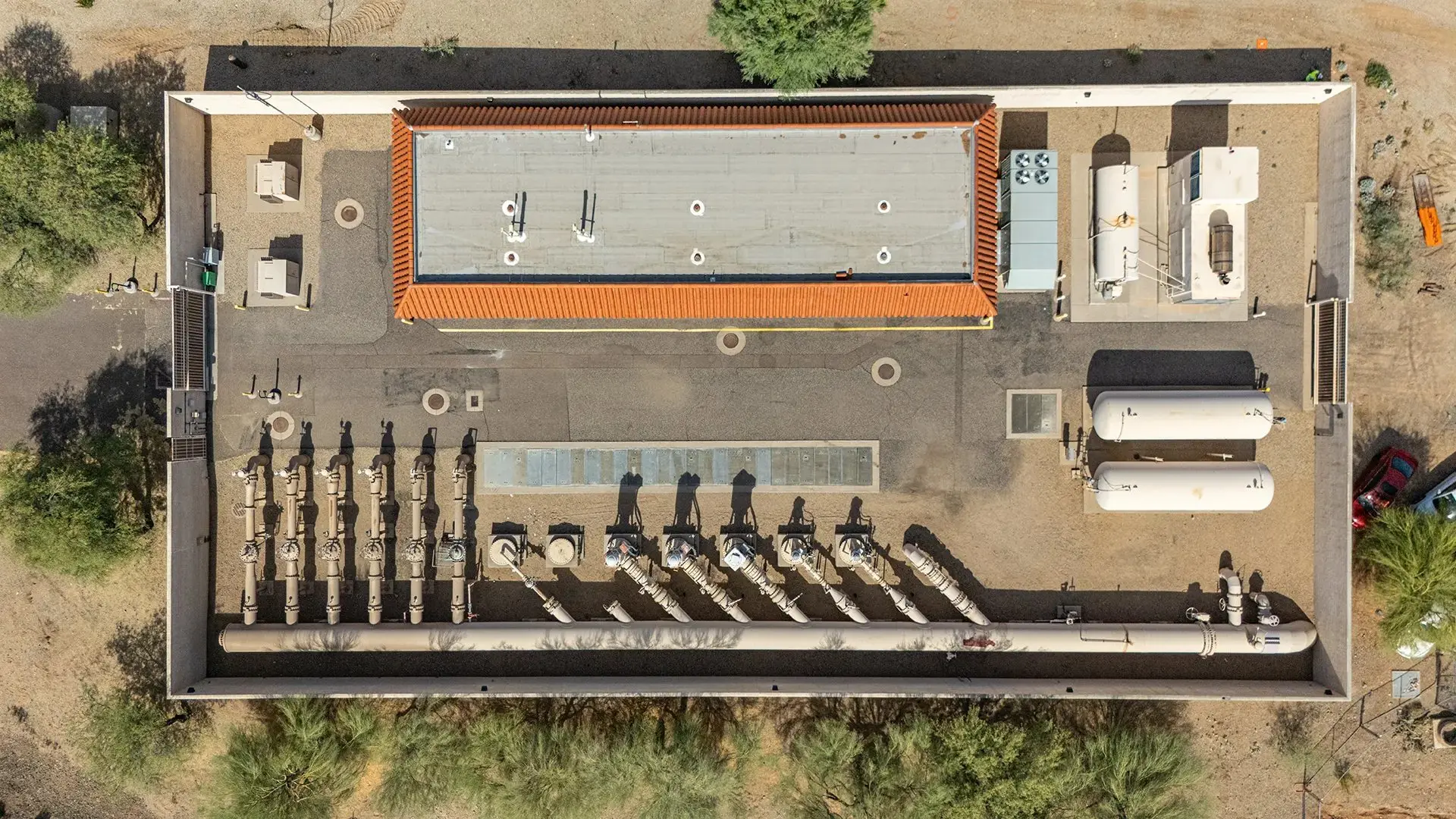 Straight-down aerial view of a commercial building roof and equipment yard