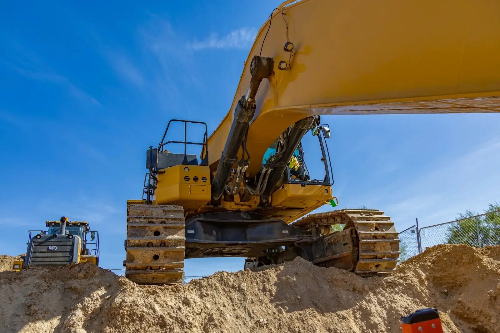 Low-angle view of an excavator cab against the sky